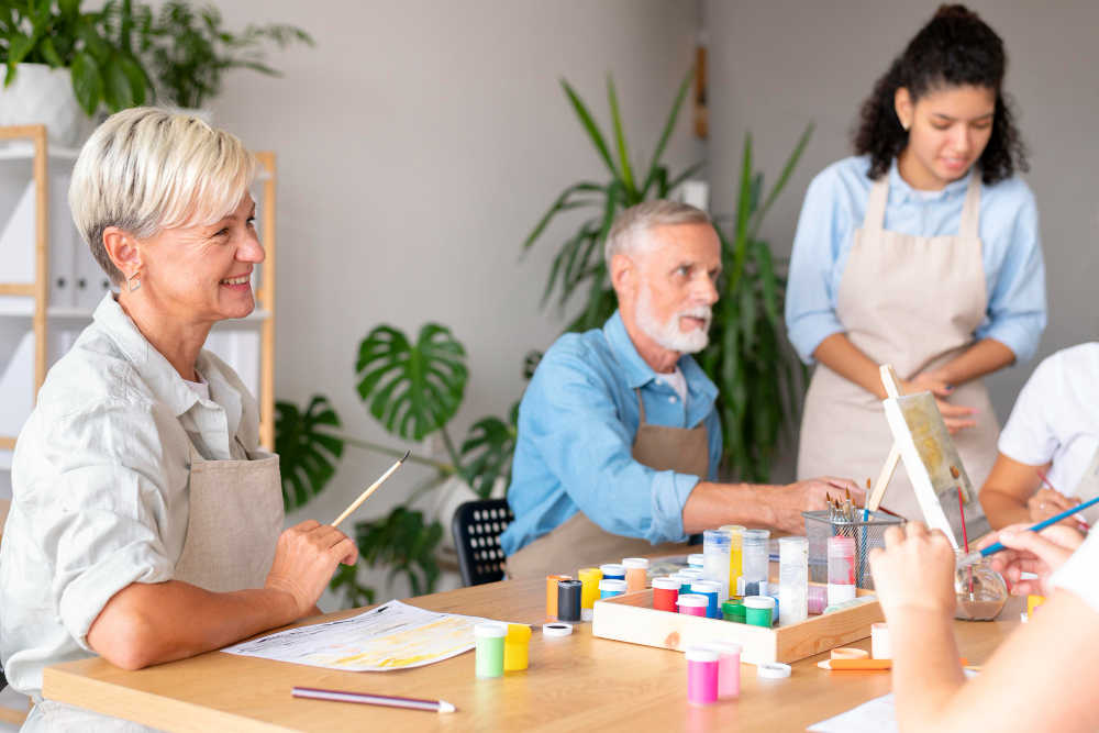 The elderly having a lovely time together and participating in arts and crafts.