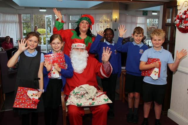 Santa and his elf gave out presents to the children from River Beach Primary School